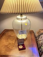 Lamp and medal on table, full view