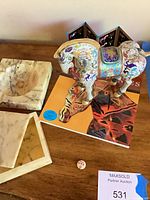 Lot overview showing cloisonné horse, book, marble items