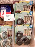 Packaged curtain grommets and Leviton wallplate box