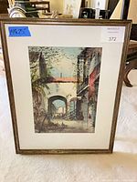 Full view of framed lithograph showing cityscape, mat and frame