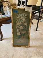 Full view of framed floral print showing gilt bamboo frame and vertical orientation
