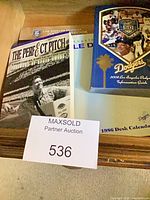 Group shot of four Dodgers publications including 2008 yearbook, 2008 info guide, 1985 The Perfect Pitch book and 1986 desk calendar