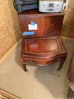 Three-quarter view of mahogany end table showing leather inlay top and legs