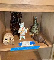 All five figurines on shelf