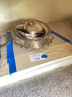 Stacked silver-plated trays, bowls and ladle