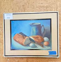 Front view of framed still life painting showing subject matter, mat and frame, size note