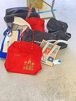 Group of six assorted bags on floor