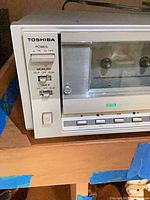 Front left view showing Toshiba branding, power and memory switches