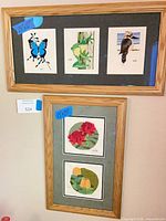 Both framed cross-stitch pieces hanging together