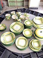 Full view of Vernonware Gingham dinnerware set on circular table showing plates, bowls, cups, creamer, sugar and covered dish
