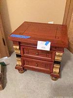 Full view of nightstand showing two drawers and gold accents