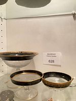 Overall view of three compotes on shelf