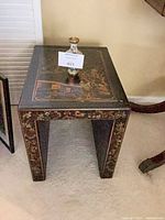 Black lacquer chinoiserie side table with small cloisonné vase on top