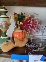 Group showing porcelain urn lamp, pumpkin vase with florals, wire chicken basket, wooden shoe lasts