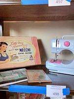 overall view showing sewing machine, box and accessories