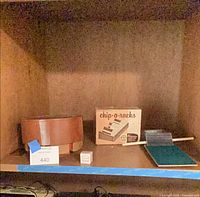 Shelf view showing wooden chip carrier, Chip-O-Racks box, felt board and chips