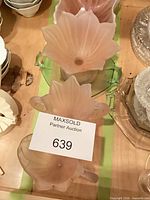 Top view showing both pink frosted water lily compotes on green underplates