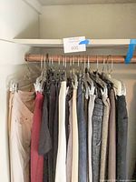 Full rack view of mixed women’s pants and jeans on hangers