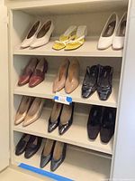 Cabinet with four shelves showing 11 pairs of women’s shoes in assorted colors and styles
