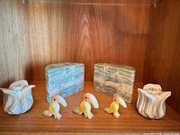 Full lot overview showing both bookends, three bird figurines, two candle holders