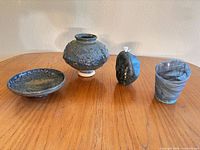 All four decorative items arranged on table