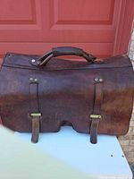 Front view showing leather, buckle straps, top handle