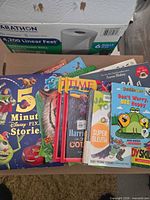 Group view of assorted children’s books spread on box
