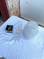 All three items on table: frosted lamp, clear tray vase, mirrored vanity jar