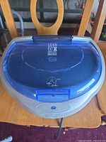 Top view of grill closed showing blue lid and logo