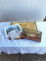 Group shot of plaque, framed print, colour print, certificate sheet, and metal easel
