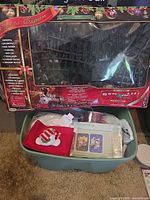 Box showing Santa Express train set and tote containing tray and decorations