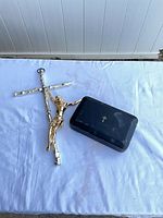 Wall crucifix beside closed black case