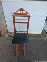 Front view of wooden valet stand with padded seat