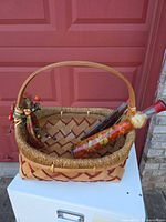 Basket with bottles inside on white surface