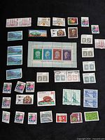 Overview of all stamps and souvenir sheet on black background