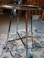 Full view of chrome rack showing circular top and four legs