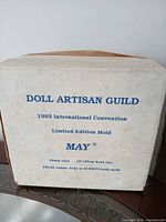 Front of Doll Artisan Guild box showing printed details
