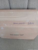Full cardboard box top with handwritten 1987 Leontine