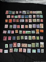 Full layout of 80 international stamps on black background