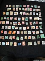 Full layout of all 100 stamps on black background