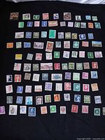 Full layout of 100 stamps on black background