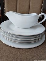 Stack of plates with gravy boat on top