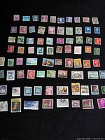 Full layout showing 80 assorted stamps on black background