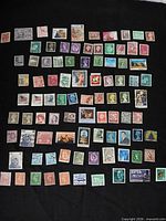 Full layout showing approximately 90 assorted stamps on black background