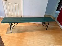 Full view of 6-foot garden bench showing wooden slats and folding metal legs