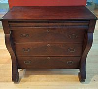 Front view showing three drawers, hardware, and overall design
