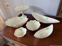 Group shot of six Lenox ivory porcelain pieces on sideboard