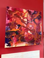 Front view of entire abstract painting on red wall