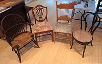 Group shot of four assorted wooden chairs