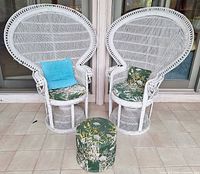Front view of both wicker chairs and ottoman showing overall design and cushions